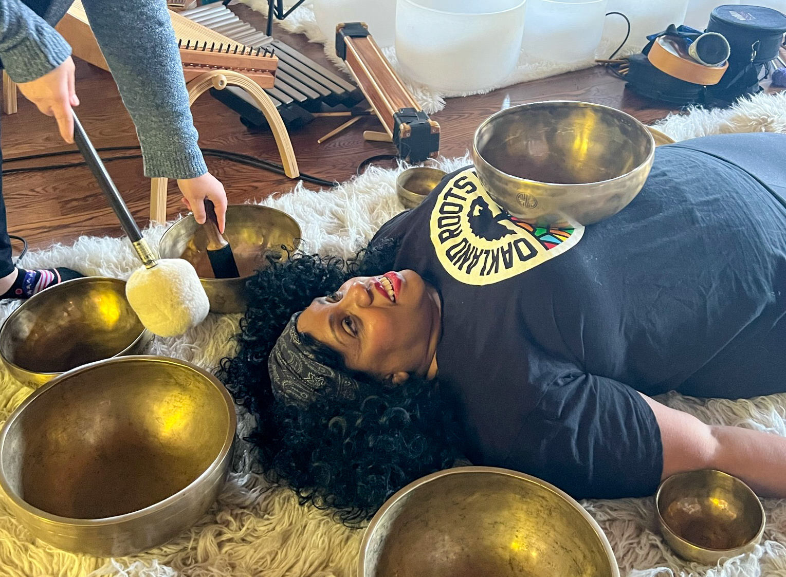 A sound bath participant receiving singing bowl therapy