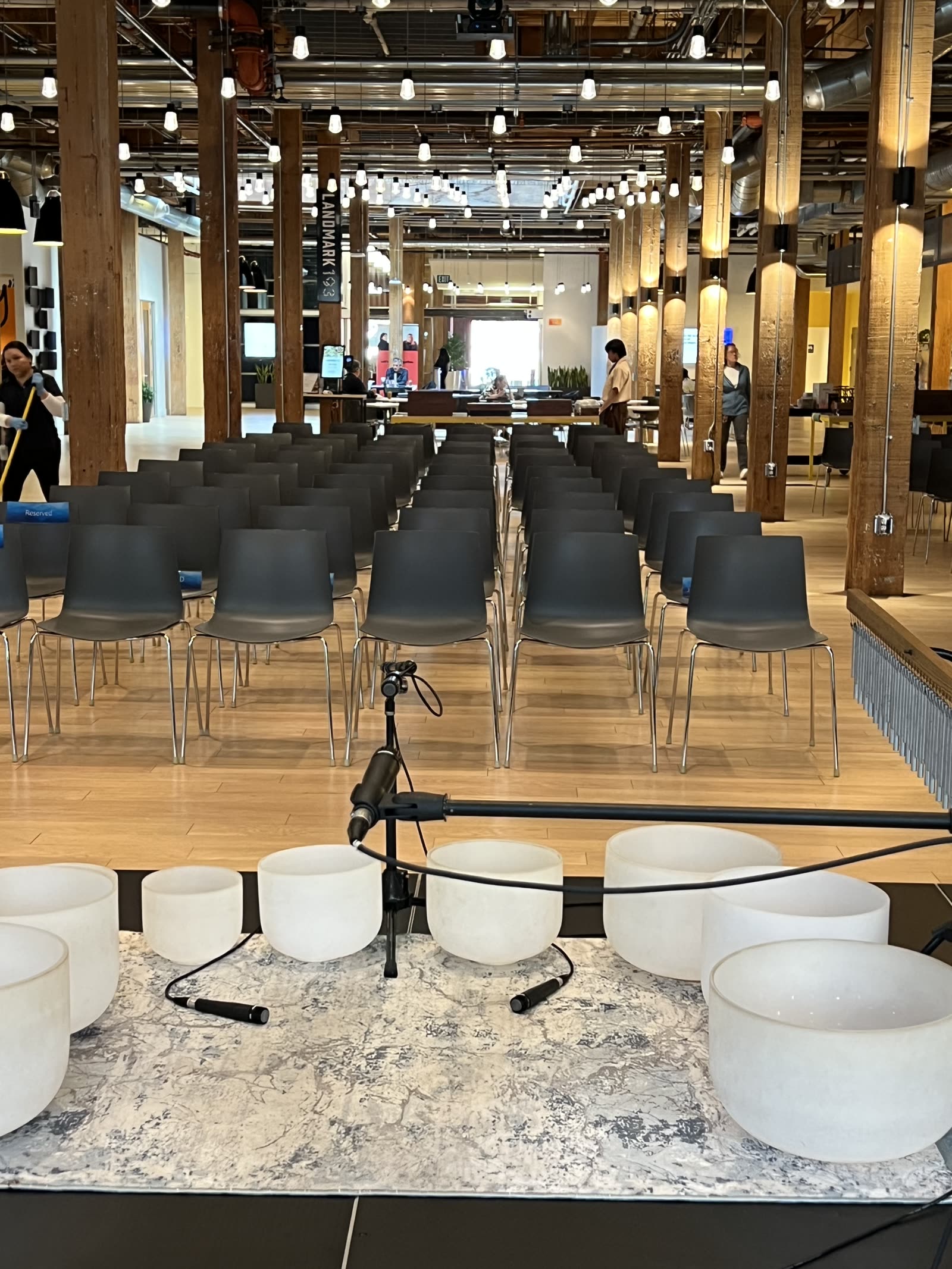 Crystal singing bowls set up before rows of chairs in a modern office