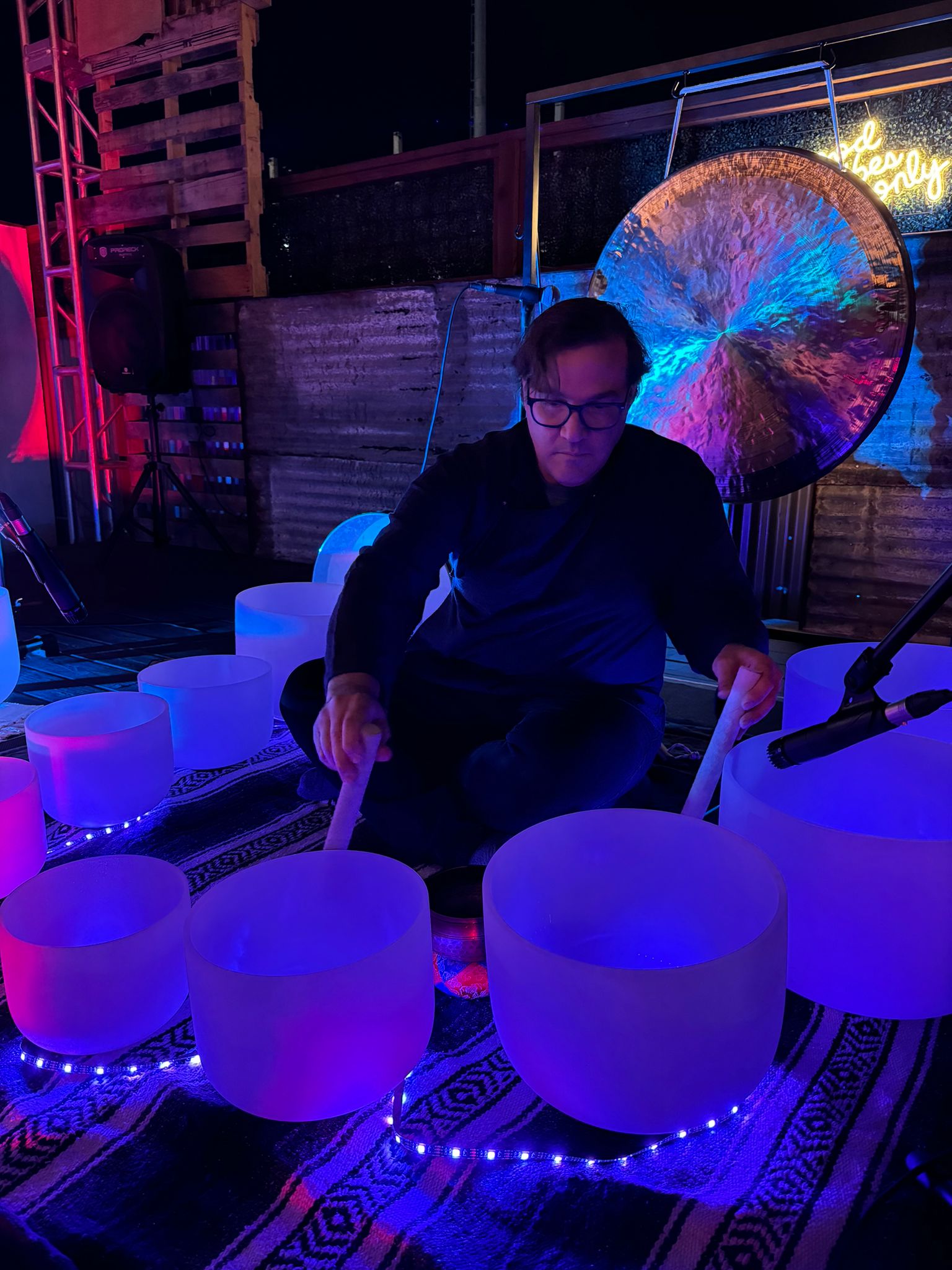 Practitioner playing a crystal singing bowl