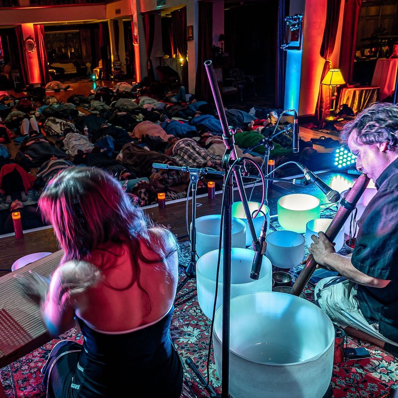 Musicians performing a sound bath with crystal bowls