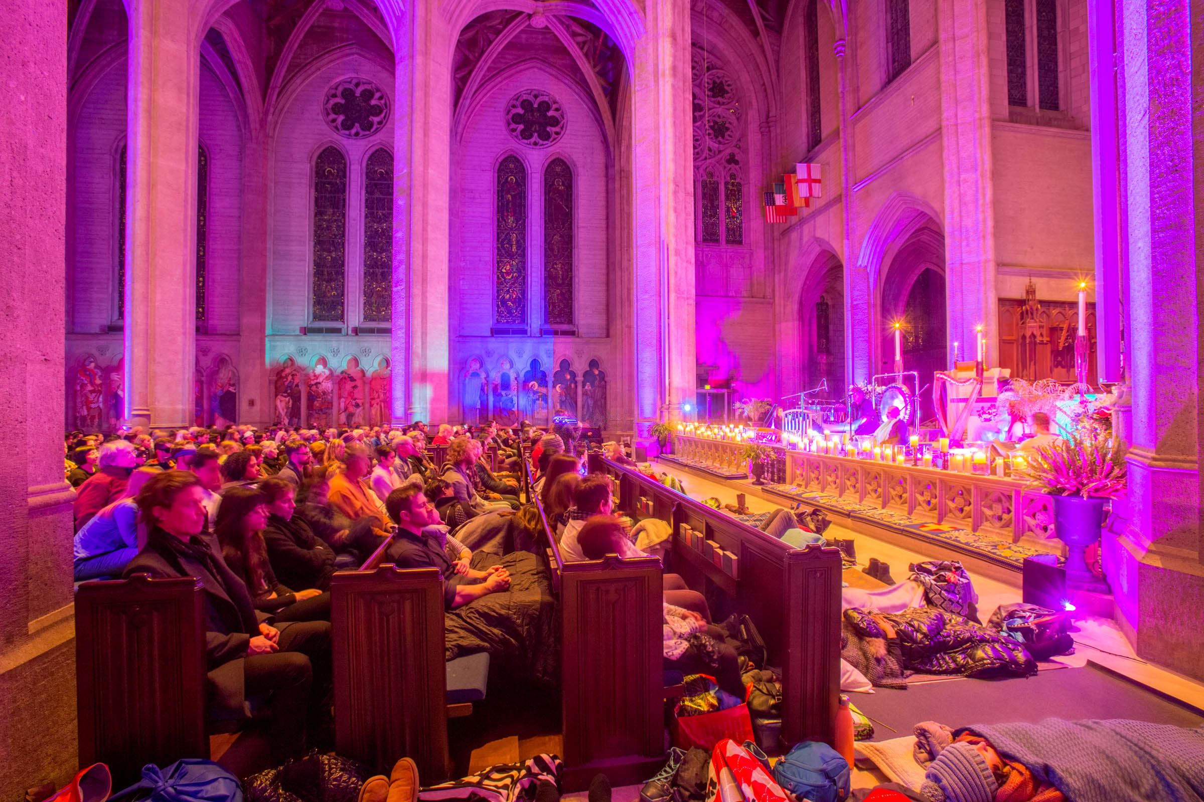 Attendees seated in pews at a sound healing event in Grace Cathedral