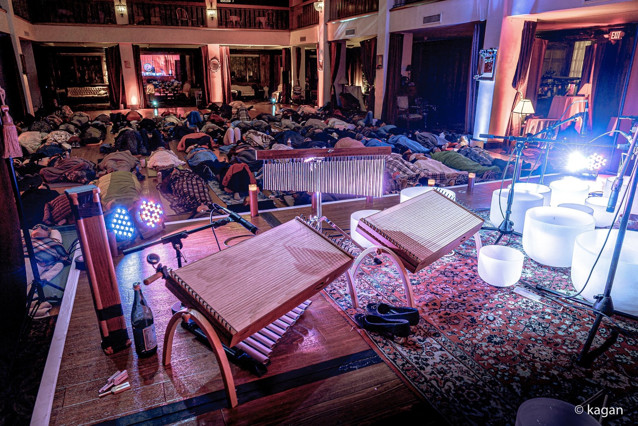 Sound healing instruments on stage with audience resting